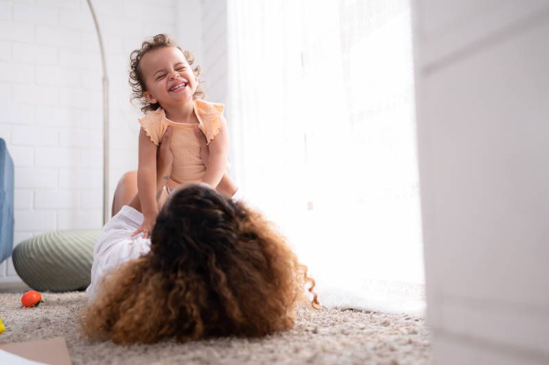 family playing on carpet floor